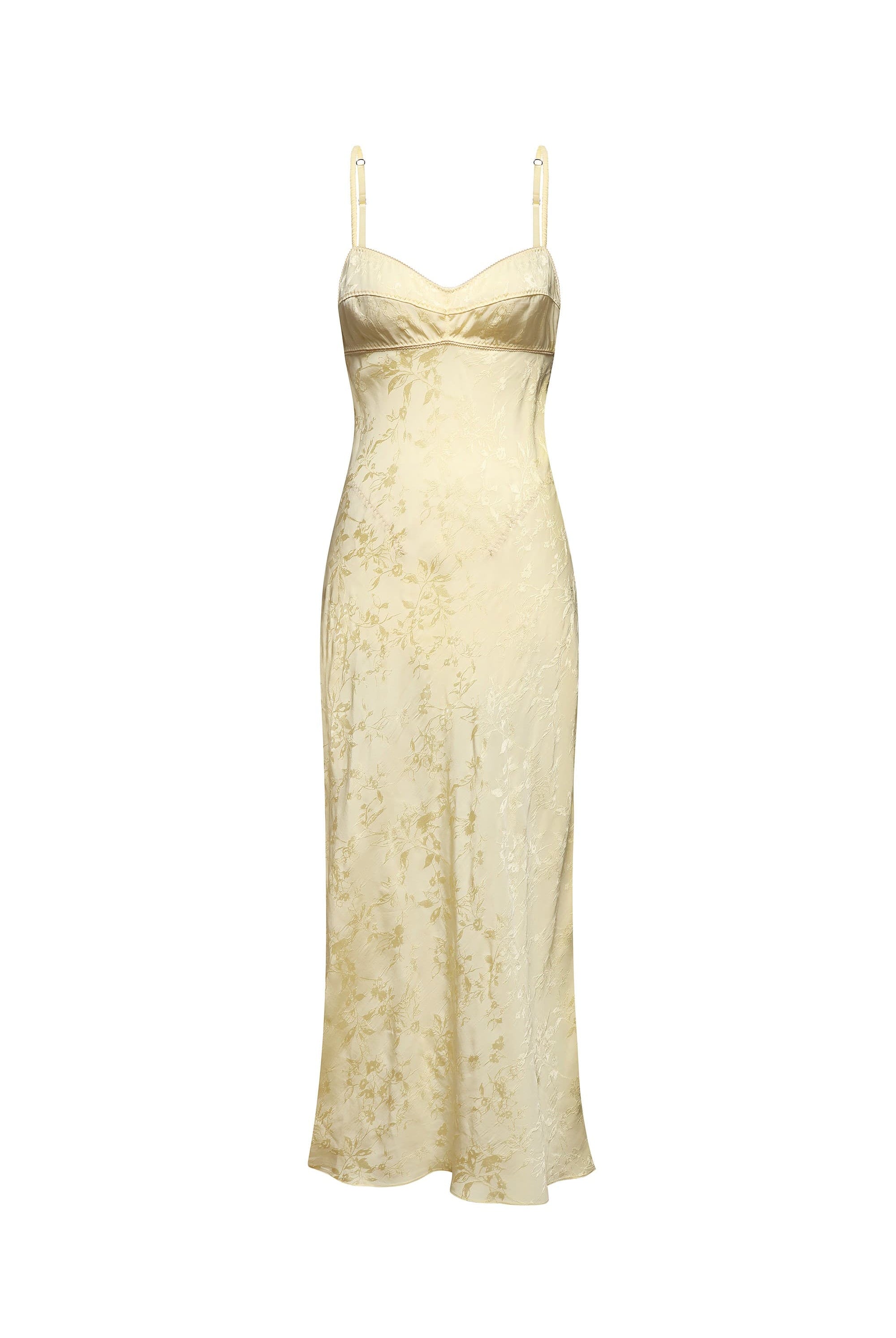 A buttermilk slip dress with a subtle floral jacquard pattern, featuring thin spaghetti straps, shown against a plain white background, front view