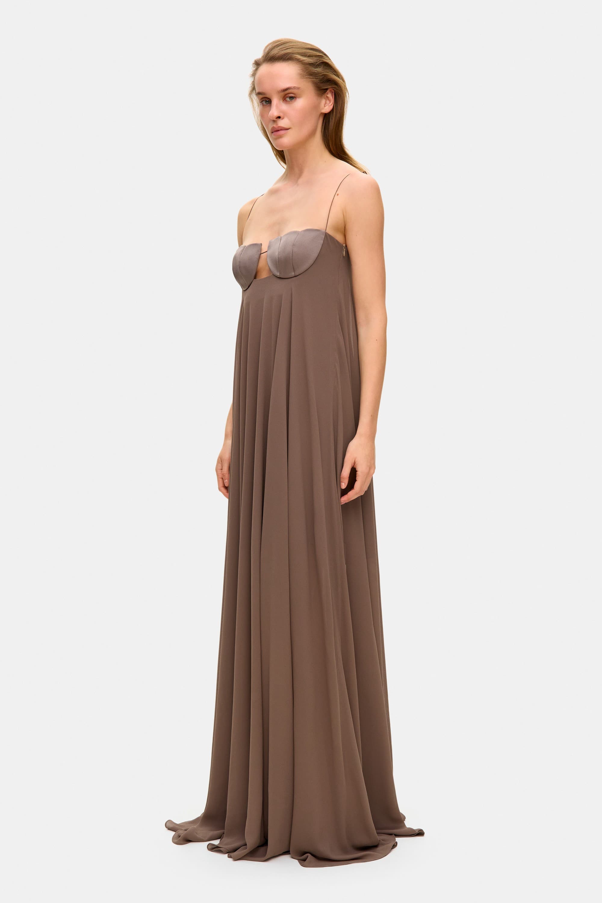 Model in Solomia maxi dress with tulip-shaped decorated cups and chiffon maxi sun skirt side view