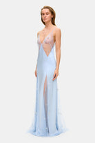 Model in fitted maxi Lolita dress with decorative embroidery all over the dress side view
