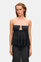 Model in wide-silhouette Clemence top with decored cups front view