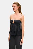 Model in wide-silhouette Clemence top with decored cups side view