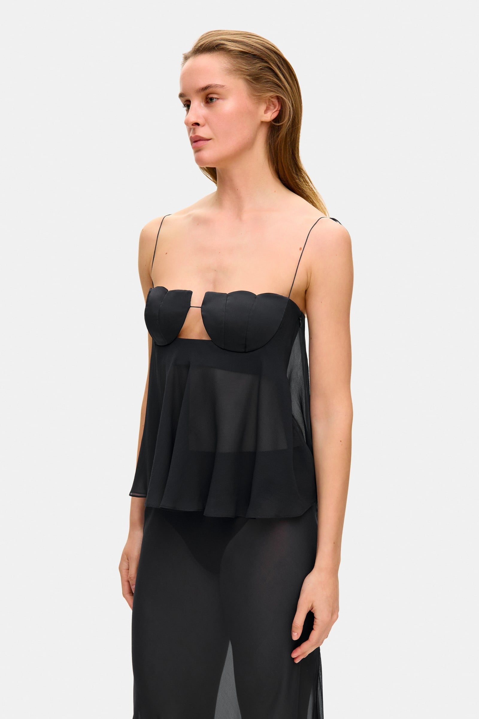 Model in wide-silhouette Clemence top with decored cups side view