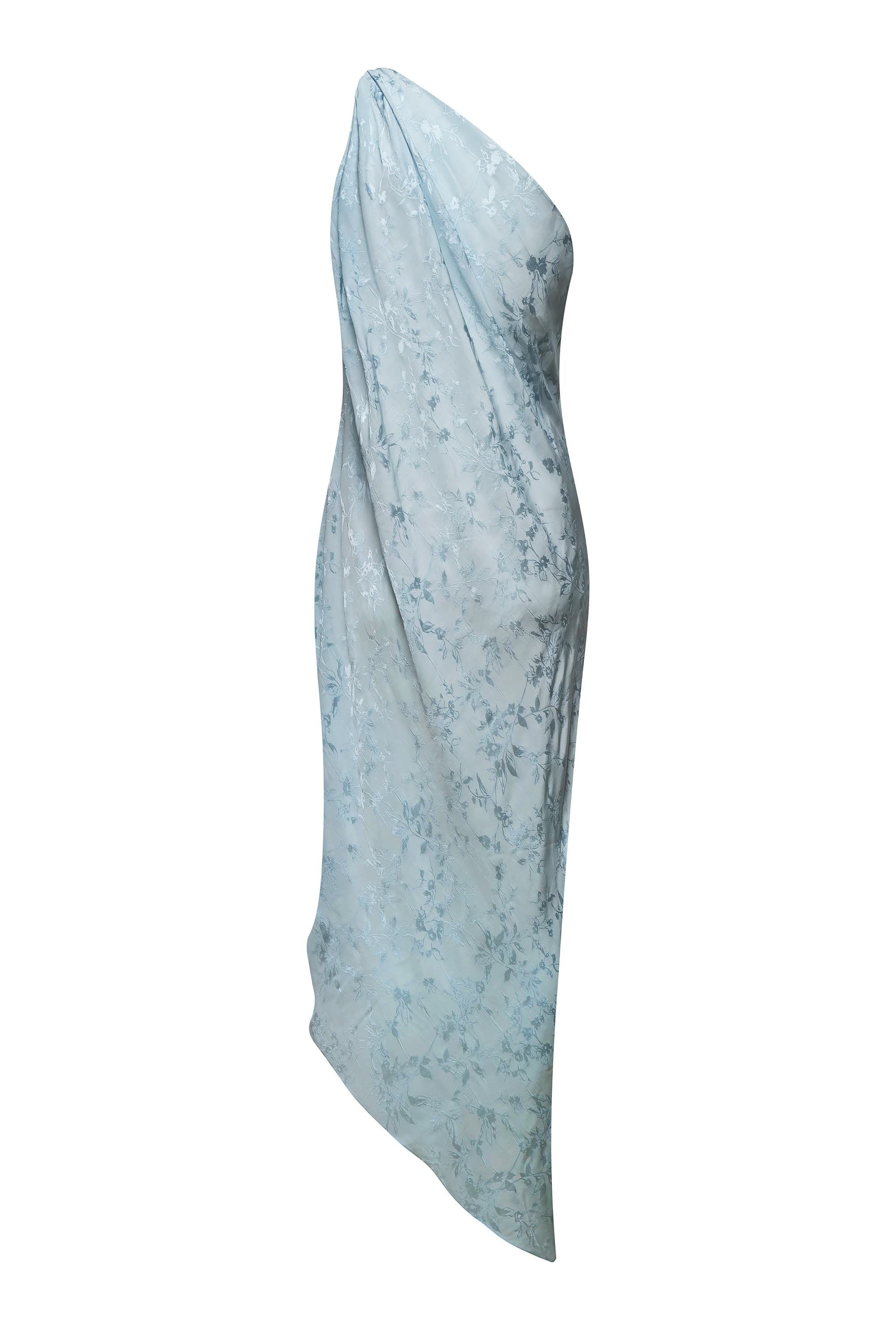 A light blue asymmetrical draped Rina dress with a textured subtle tonal floral pattern, shown against a plain white background, front view