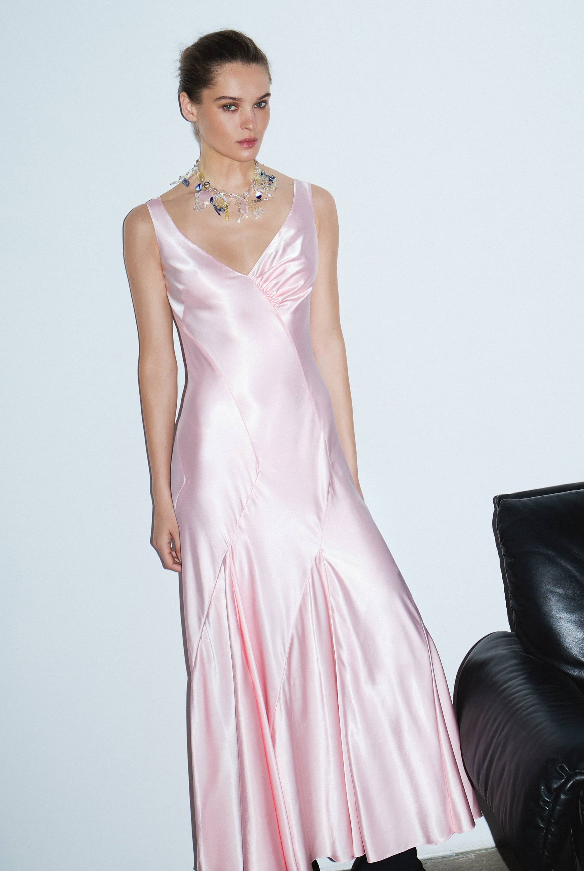 Woman wearing a light pink Liza dress against a white background