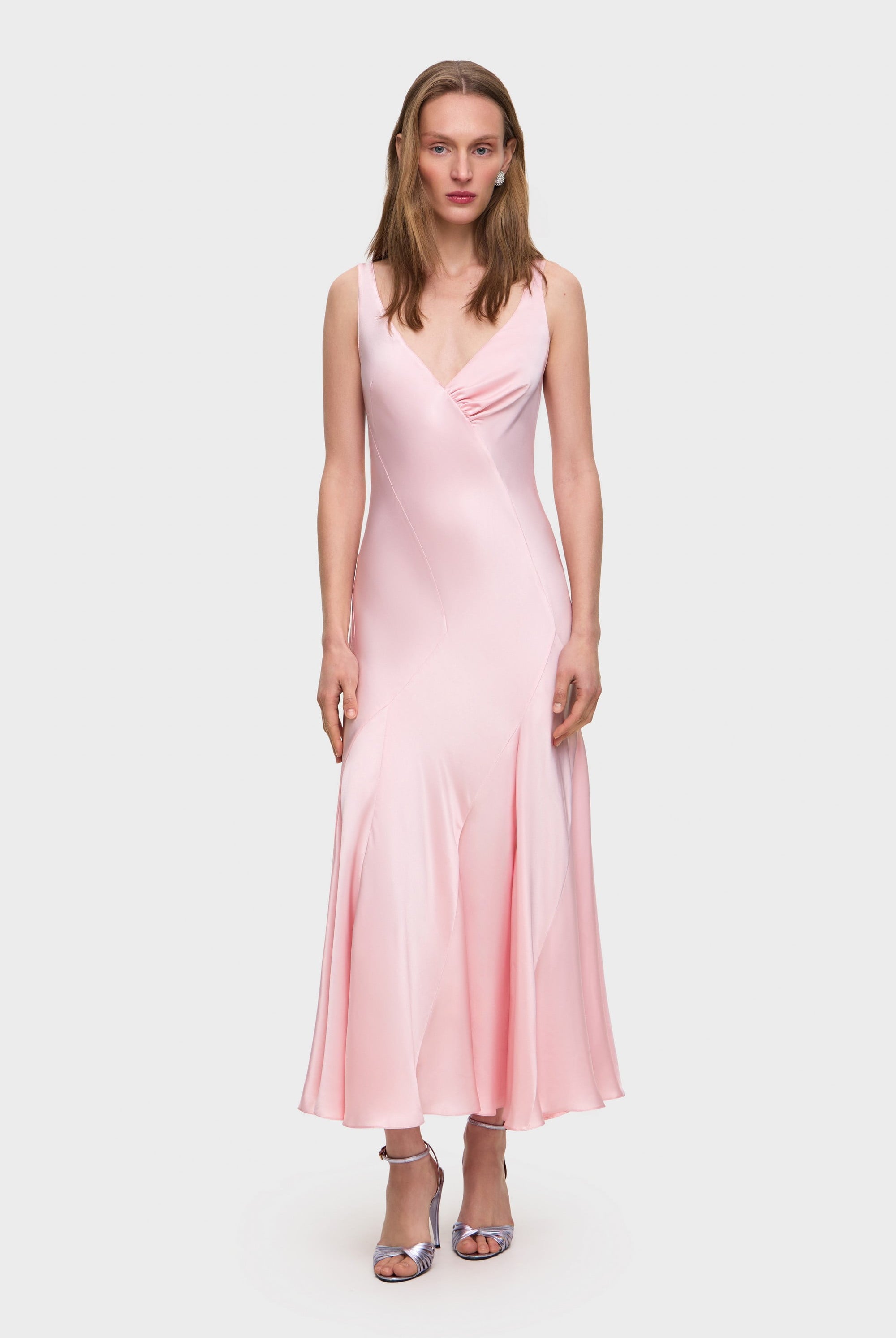 Woman wearing a pink Liza dress on a white background, front view