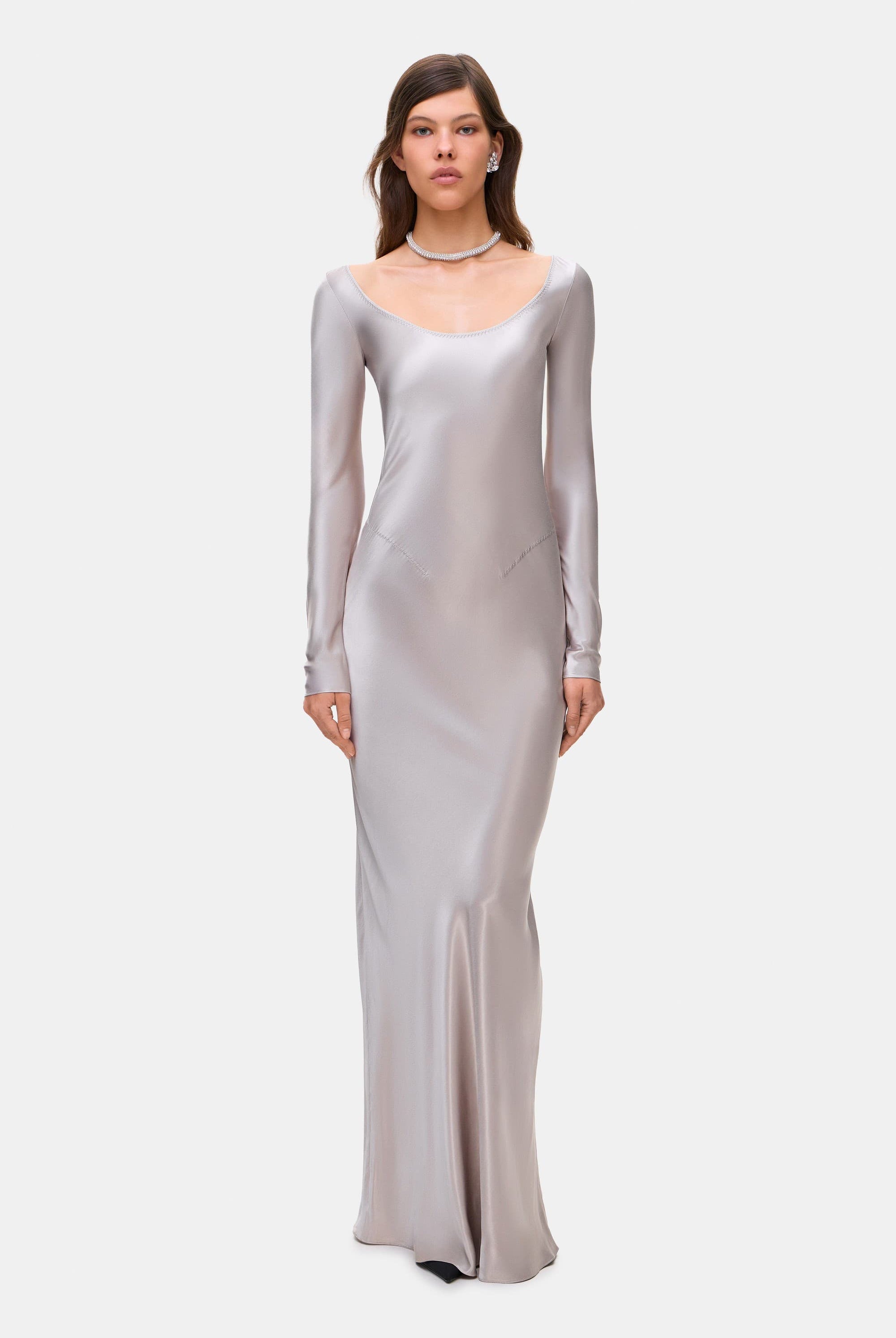 Woman wearing a silver long-sleeve Margit dress on a white background, front view
