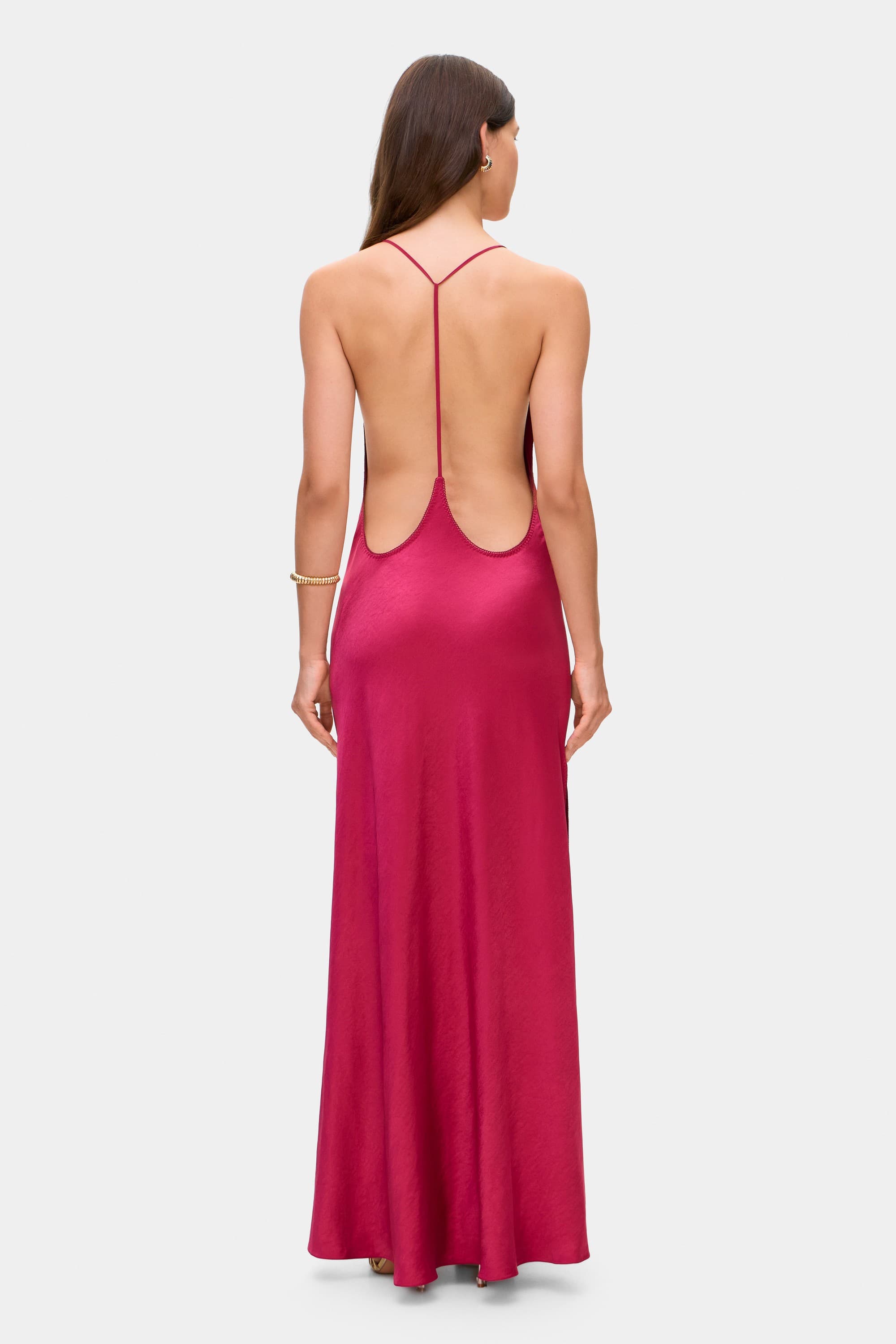 Woman wearing a berry Justina dress on a white background, back view