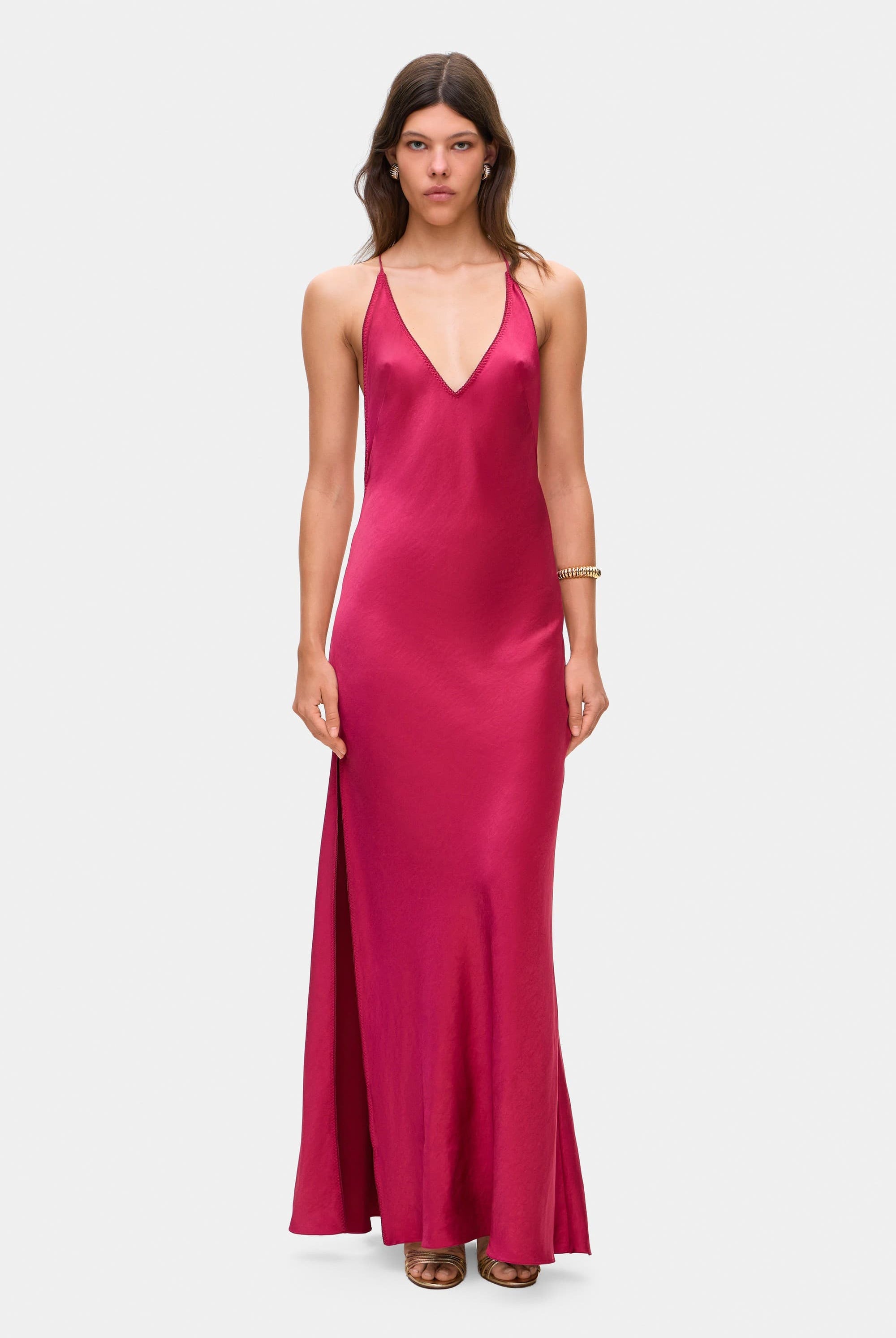 Woman wearing a berry Justina dress on a white background, front view