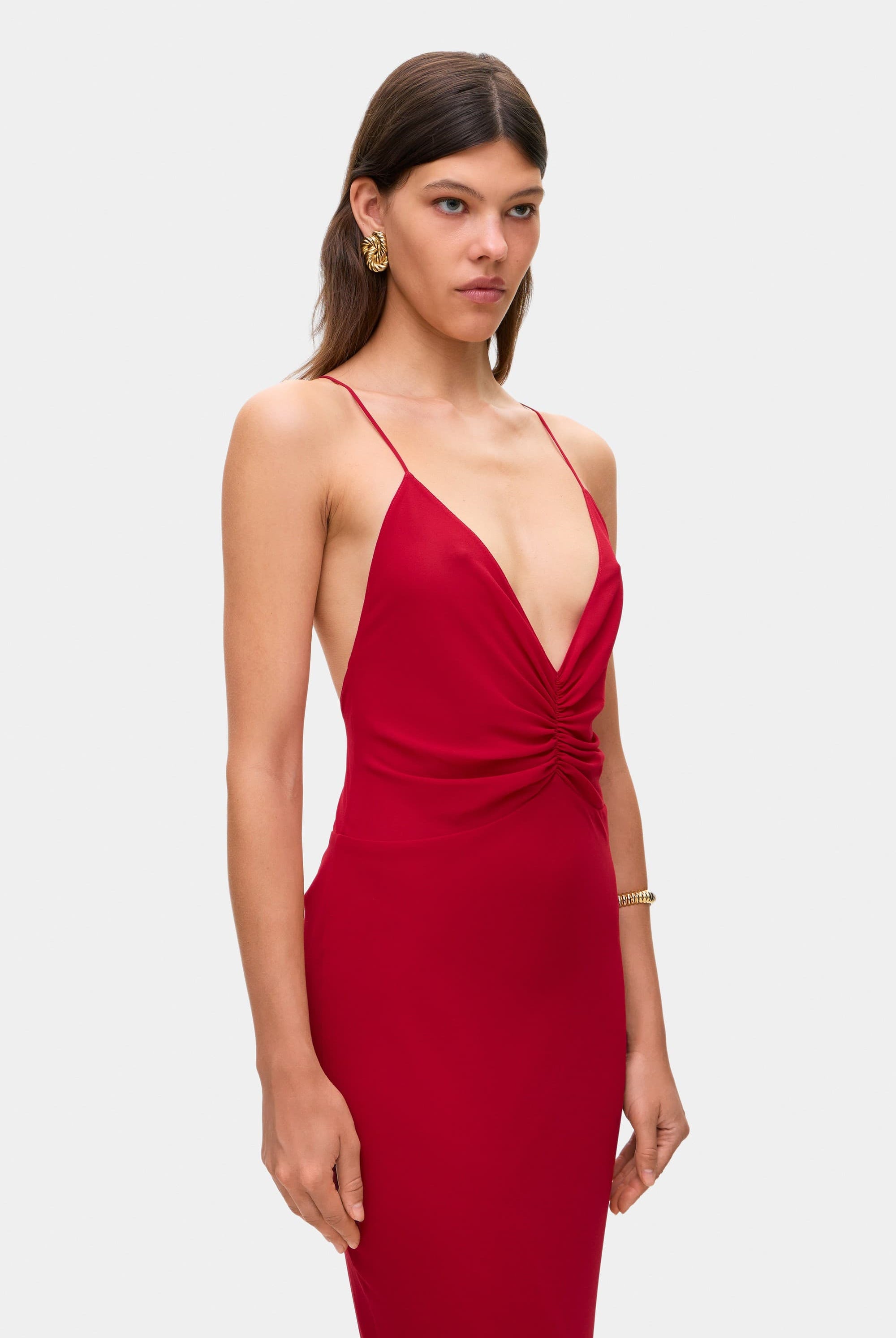 Woman wearing a berry Maltina dress on a white background, side details view