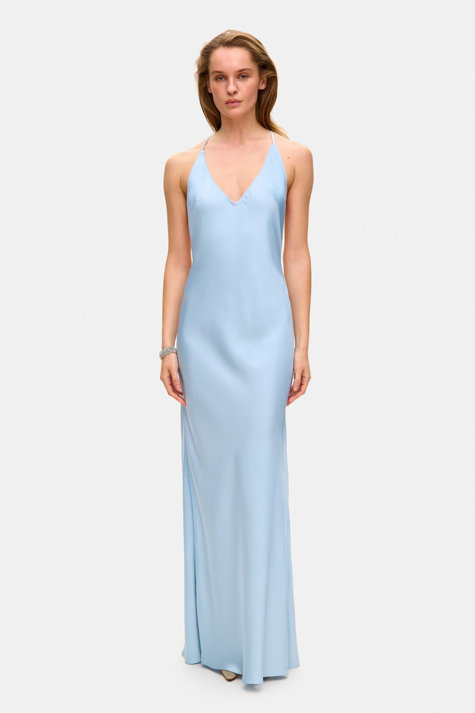 Model in open back Justina maxi dress with open shoulders front view