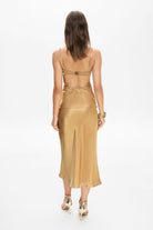 Model in midi Champaca skirt with stitches on hips back view