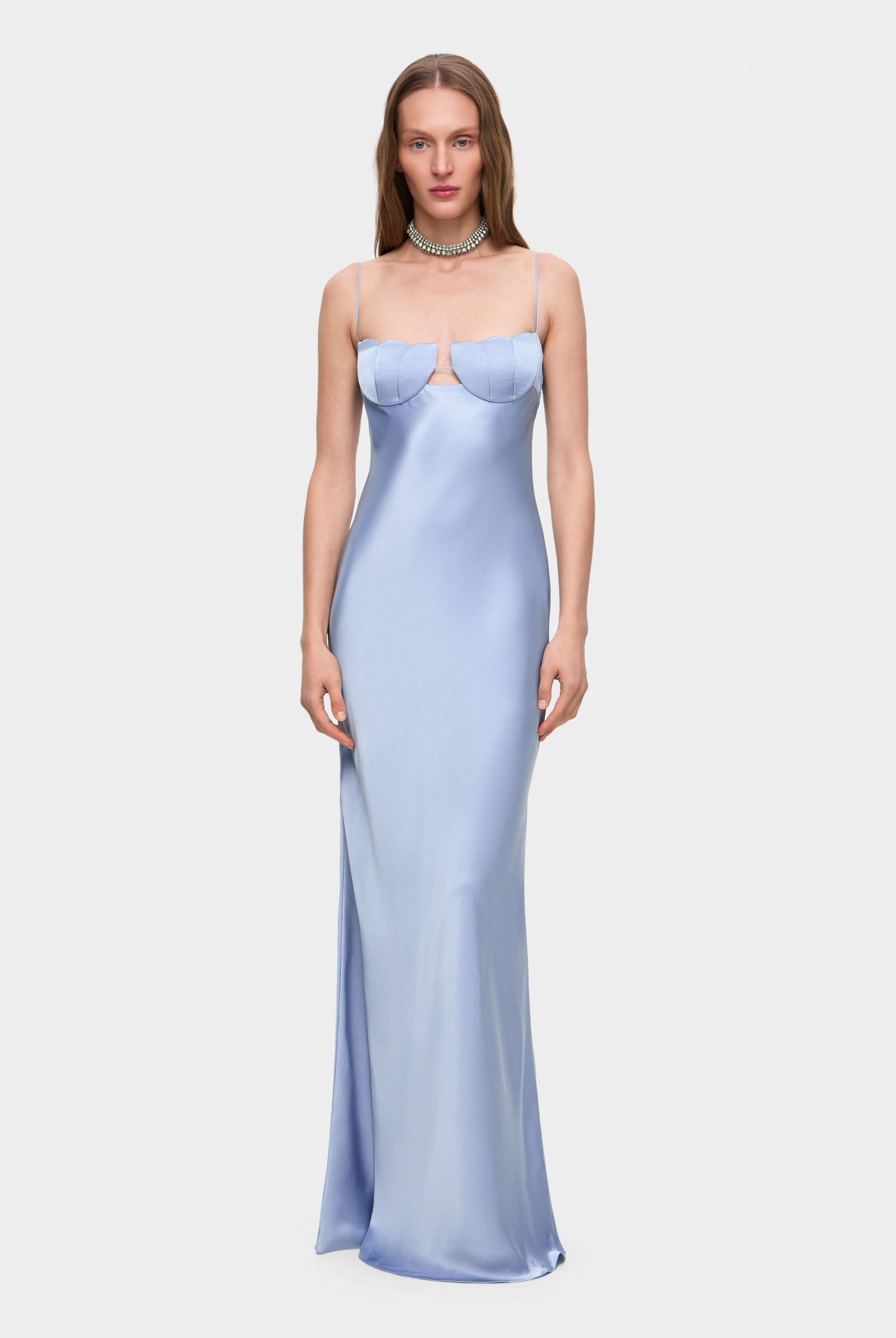 Woman wearing a light blue with thin straps Tulip dress against a white background, front view