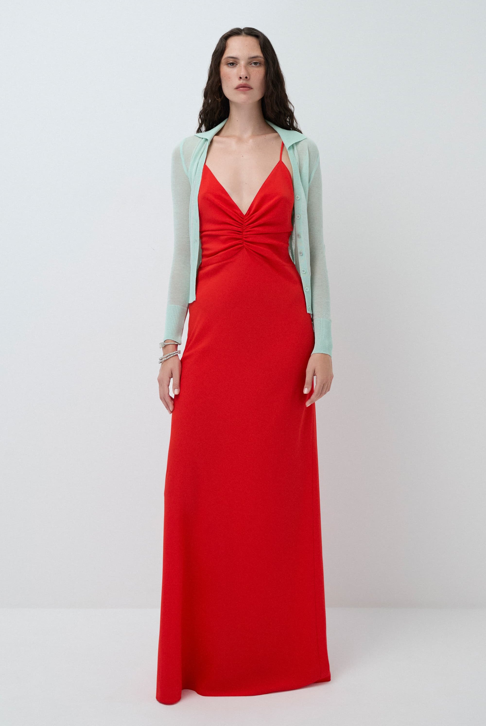 Woman wearing a coral Eliana dress with a mint Ensley cardigan on a white background, front view