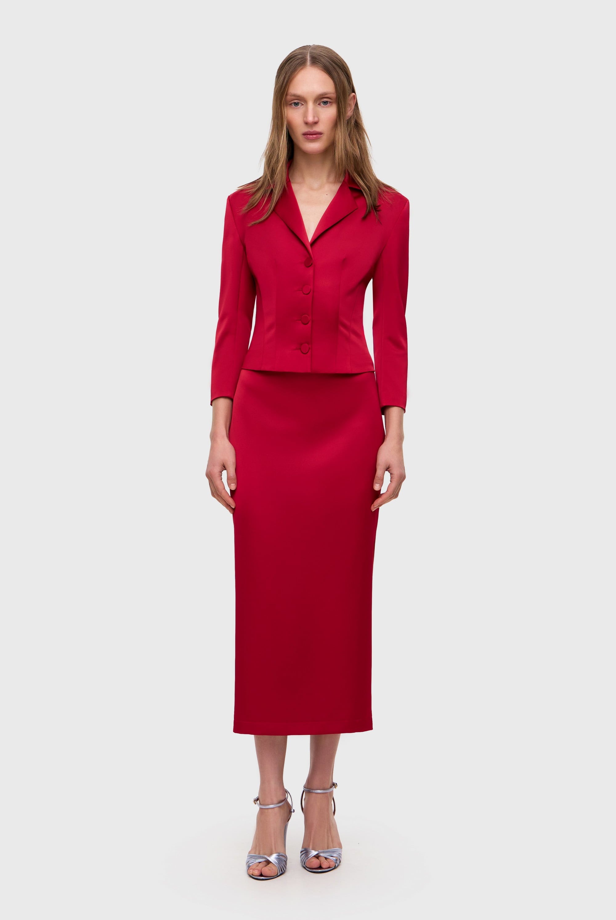 Woman wearing a red Giada jacket on a white background, front view