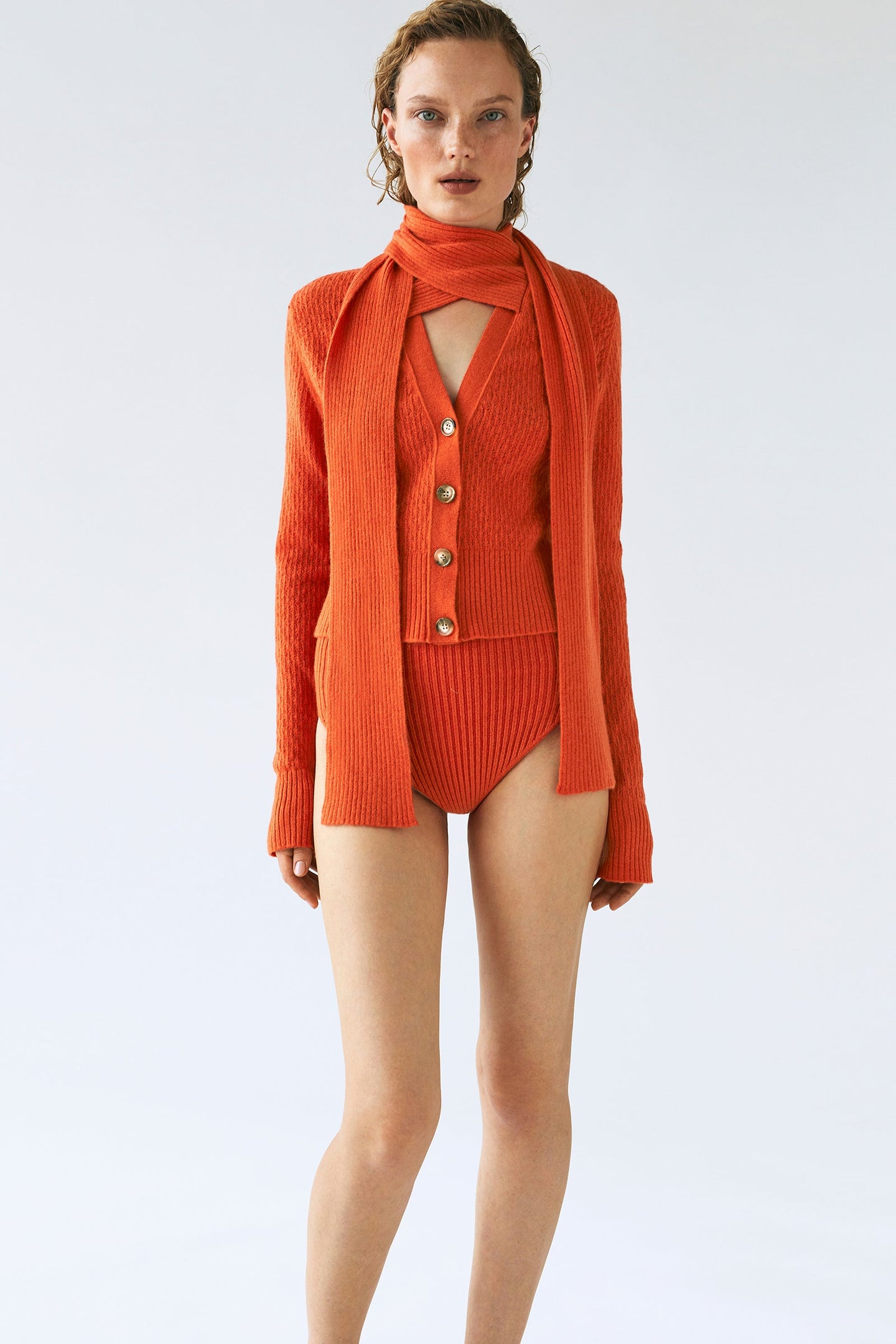 Model in orange Eliana cardigan