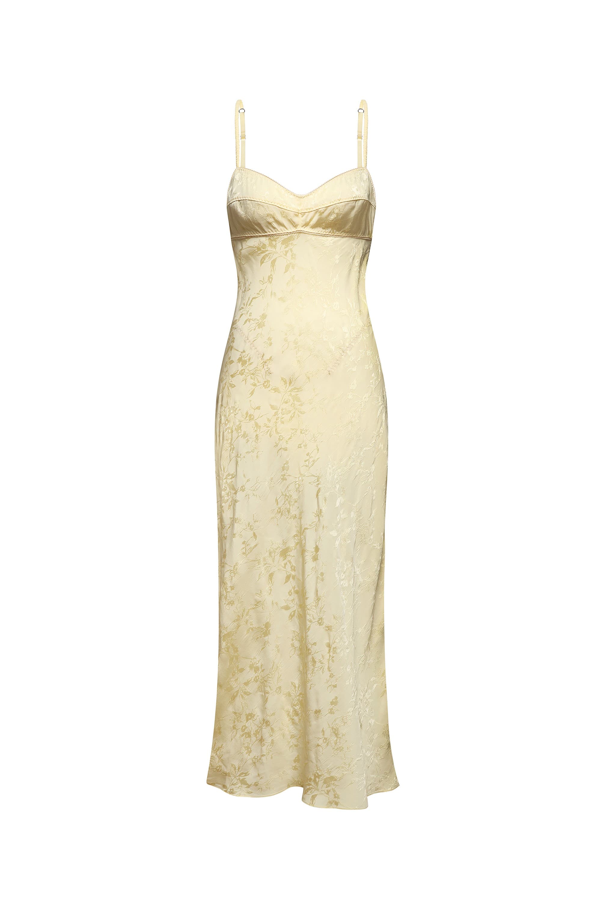 A buttermilk slip dress with a subtle floral jacquard pattern, featuring thin spaghetti straps, shown against a plain white background, front view