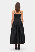 Model in Chloé midi dress with a corset top with stitching and wide skirt back view