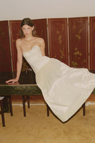 Model in Chloé midi dress with a corset top with stitching and wide skirt