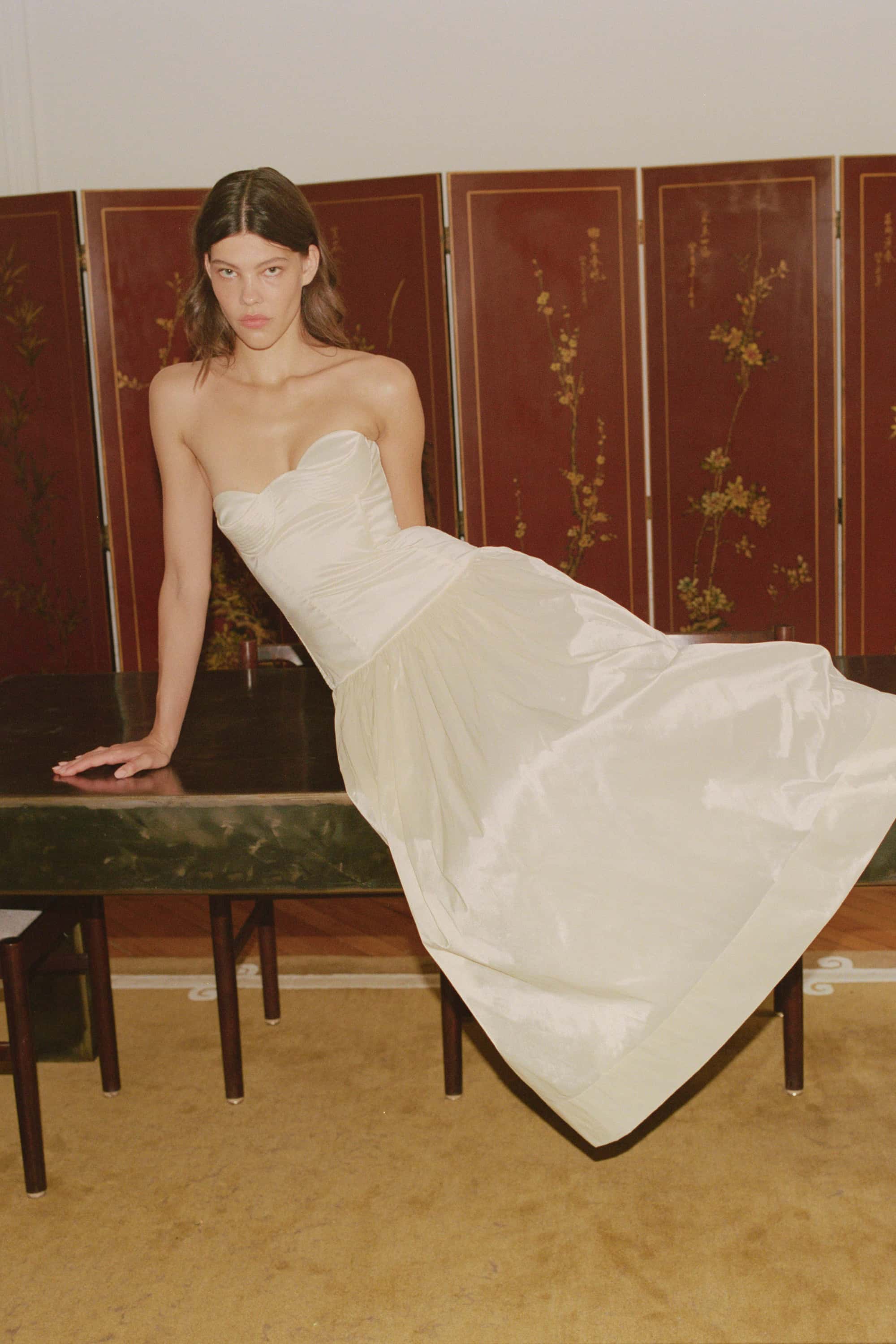Model in Chloé midi dress with a corset top with stitching and wide skirt
