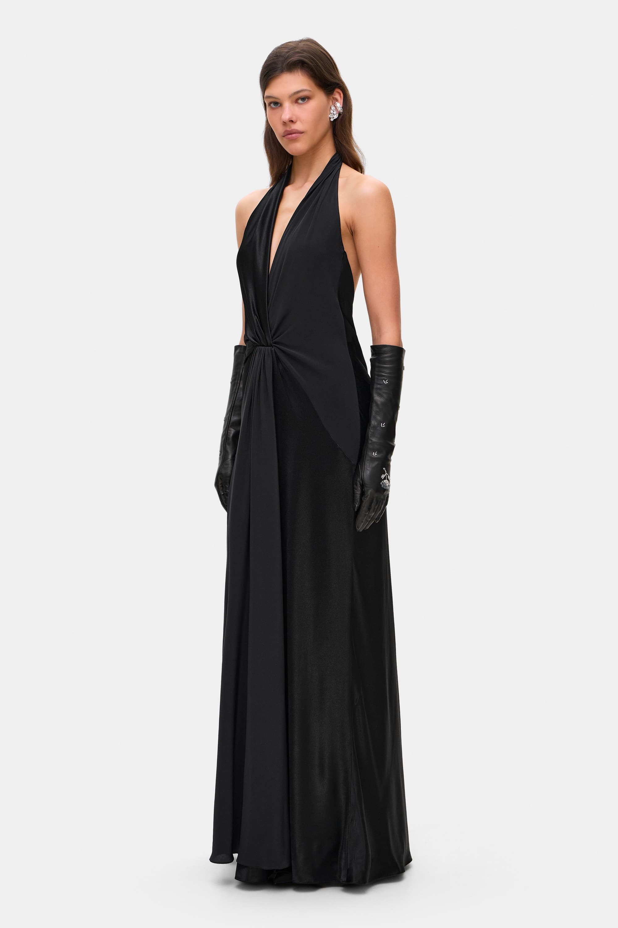 Model in open back Ruth maxi dress with decorative draping on the front, side view