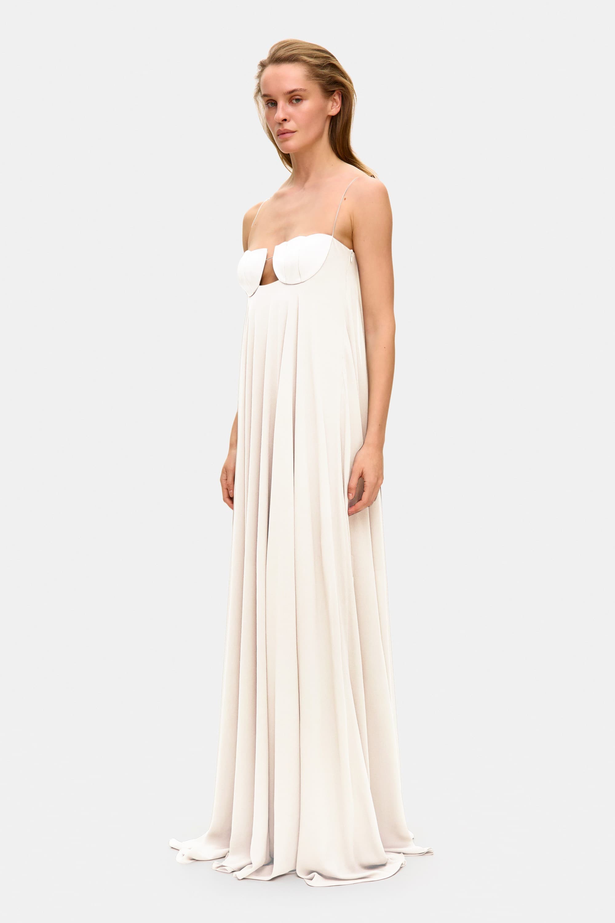 Model in Solomia maxi dress with tulip-shaped decorated cups and chiffon maxi sun skirt side view