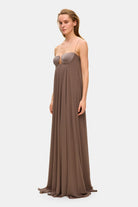 Model in Solomia maxi dress with tulip-shaped decorated cups and chiffon maxi sun skirt side view