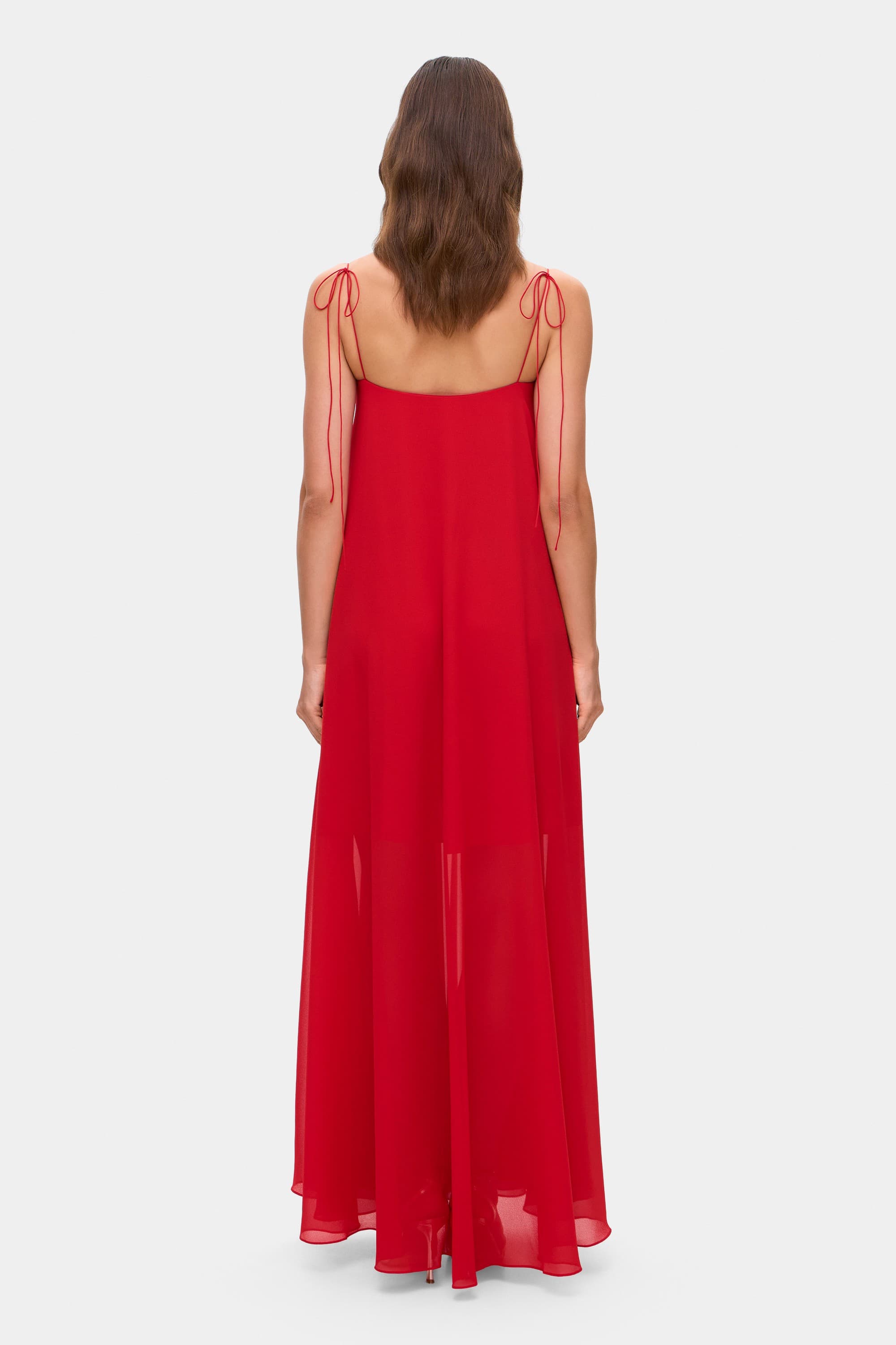 Model in Solomia maxi dress with tulip-shaped decorated cups and chiffon maxi sun skirt back view