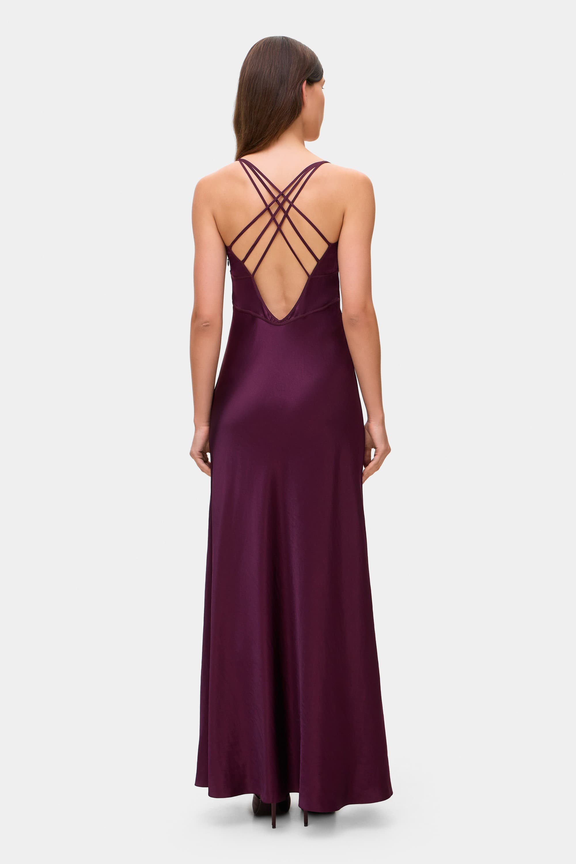 Model in Melania maxi dress with decorative lines on the bodice back view