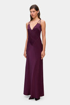 Model in Melania maxi dress with decorative lines on the bodice side view