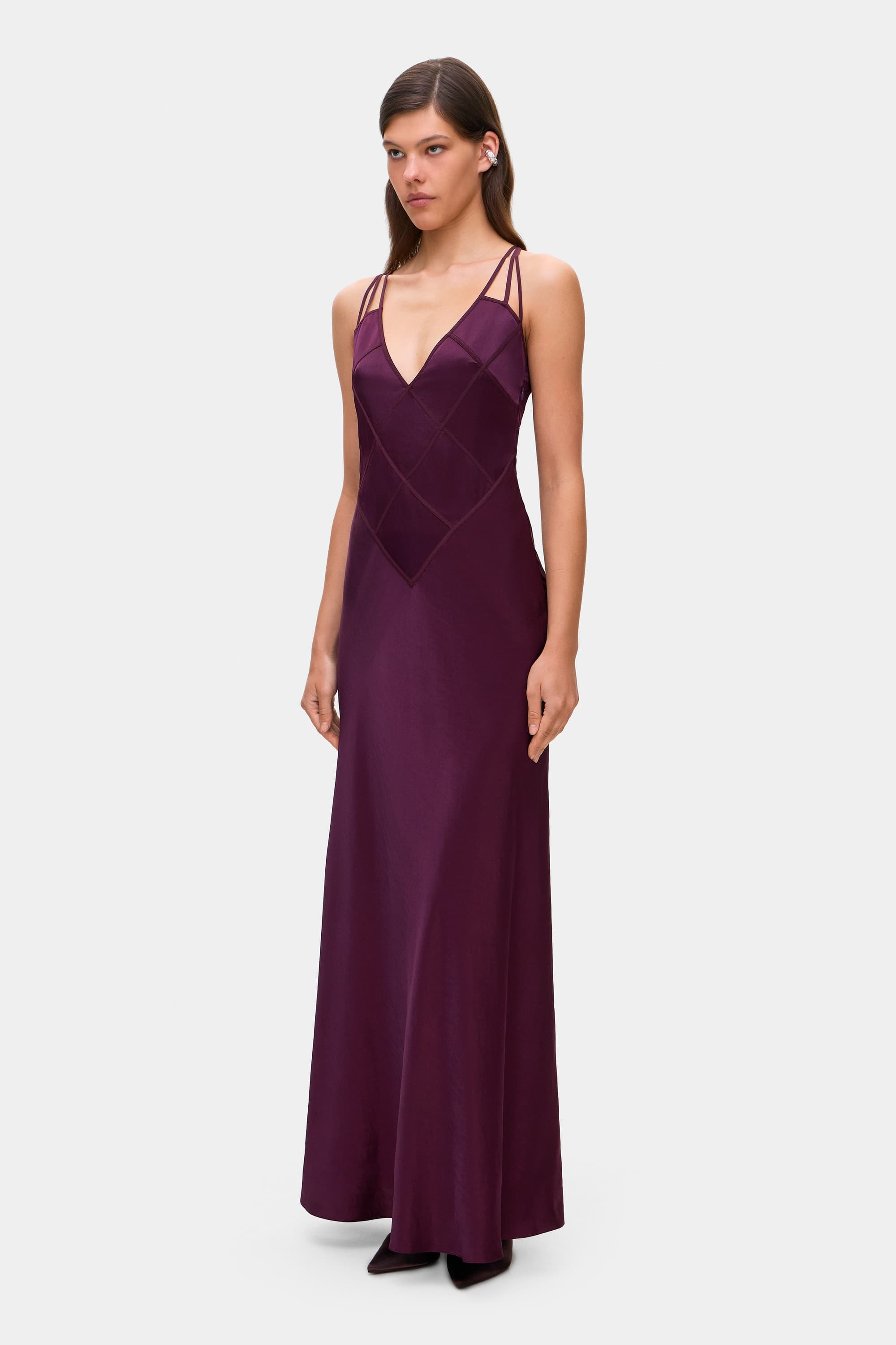 Model in Melania maxi dress with decorative lines on the bodice side view