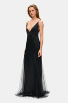 Model in fitted maxi Adelina dress side view