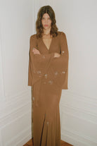 Model in wrap Marika blouse with embroidered sleeves