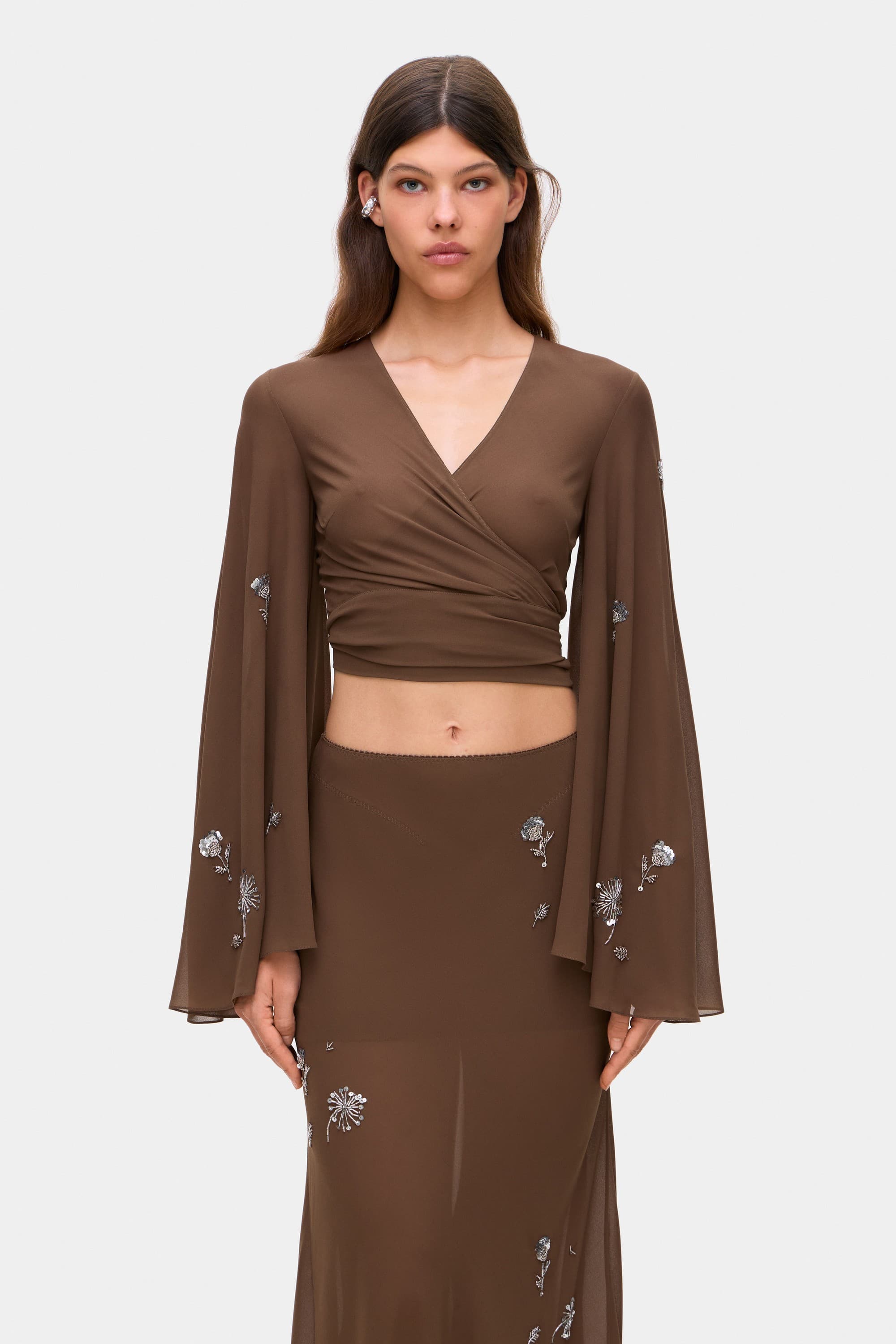 Model in wrap Marika blouse with embroidered sleeves front view