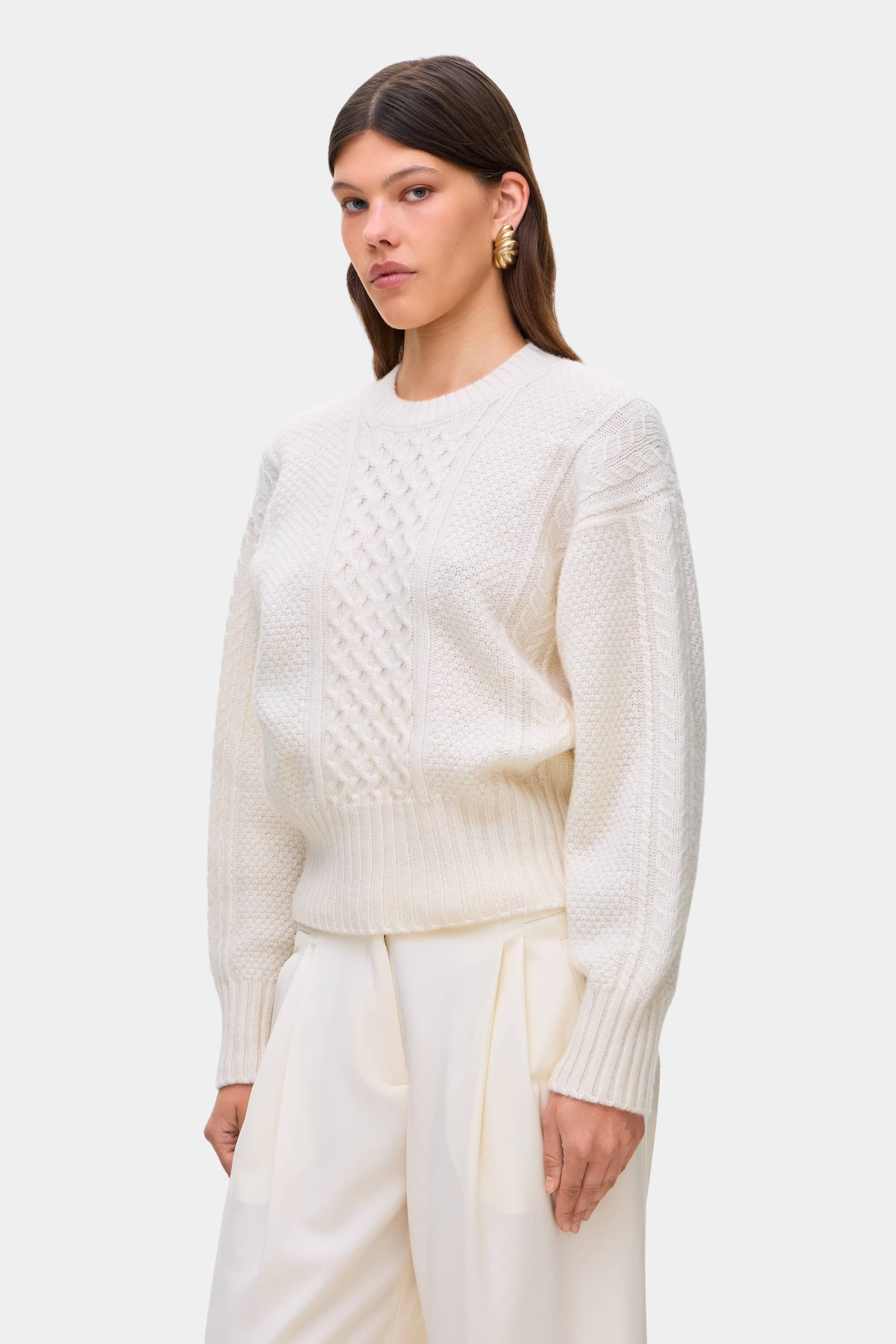 Model in cable knit Verona jumper side view