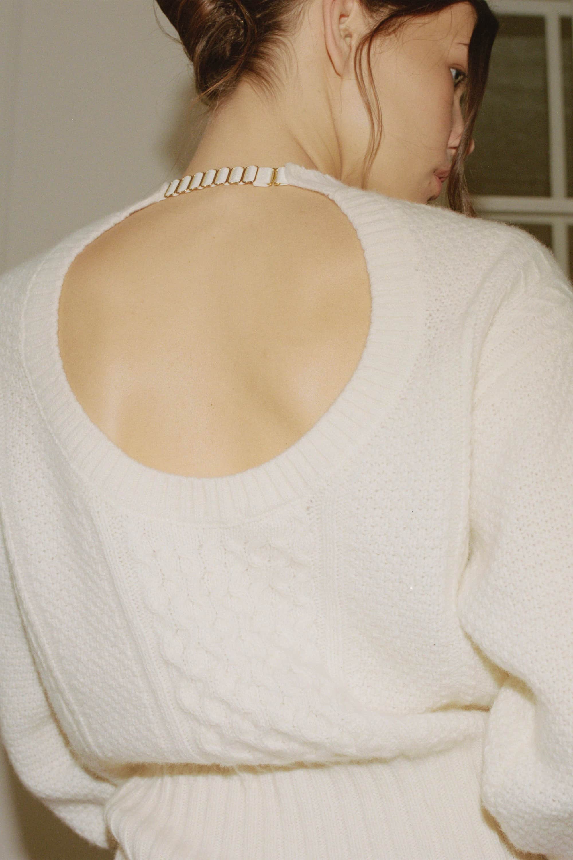 Model in cable knit Verona jumper back view