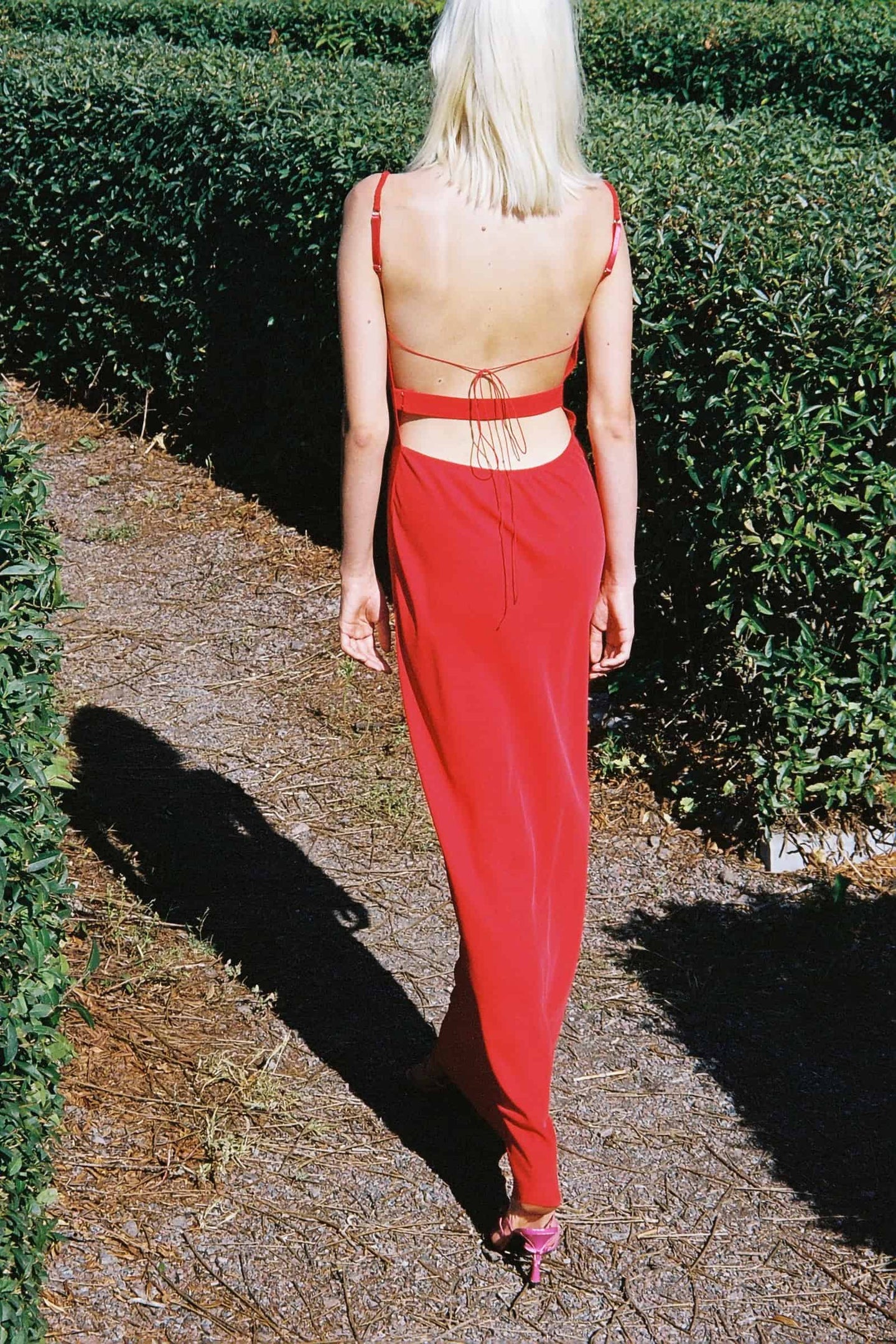 Model in red Yelena dress back view