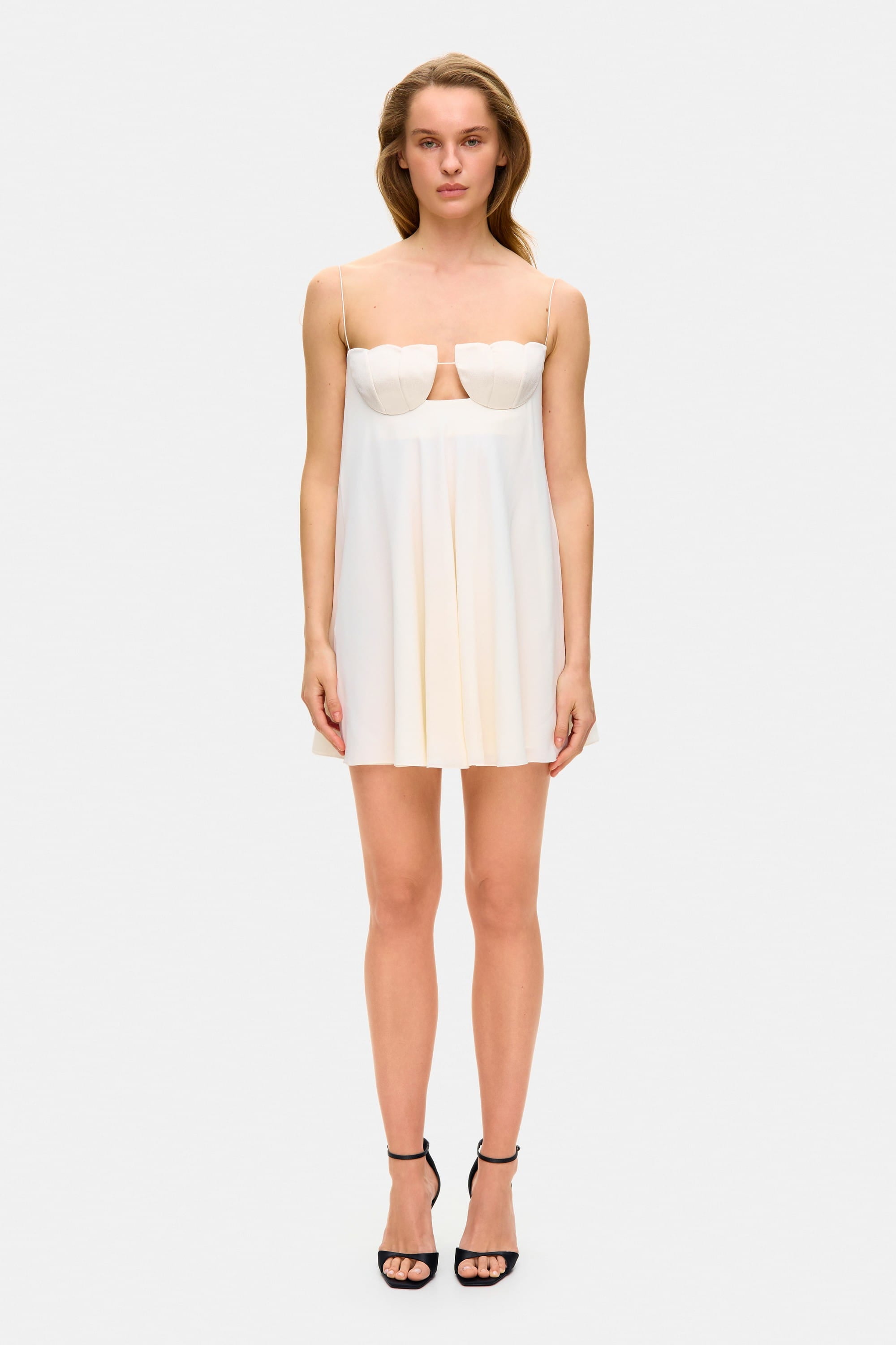 Model in loose Tonia mini dress with tulip-shaped decorated cups and straps tied into bows front view