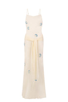 Zoe maxi dress with decorative scarf at the hips, featuring embroidery elements throughout the dress front view