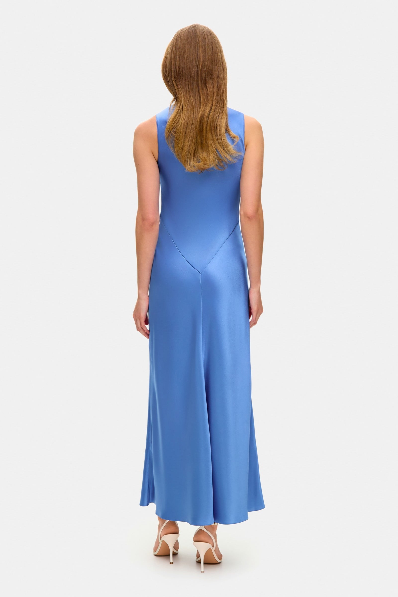 Model in midi fitted Lydia dress with a flared shape starting from the hips back view