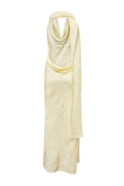 A pale yellow halter-neck maxi Kelly dress with a draped, cowl-like neckline and a subtle tonal textured pattern, shown against a plain white background, back view