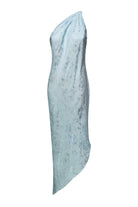 A light blue asymmetrical draped Rina dress with a textured subtle tonal floral pattern, shown against a plain white background, back view
