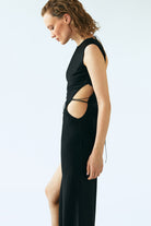 Model in Shu black dress side view