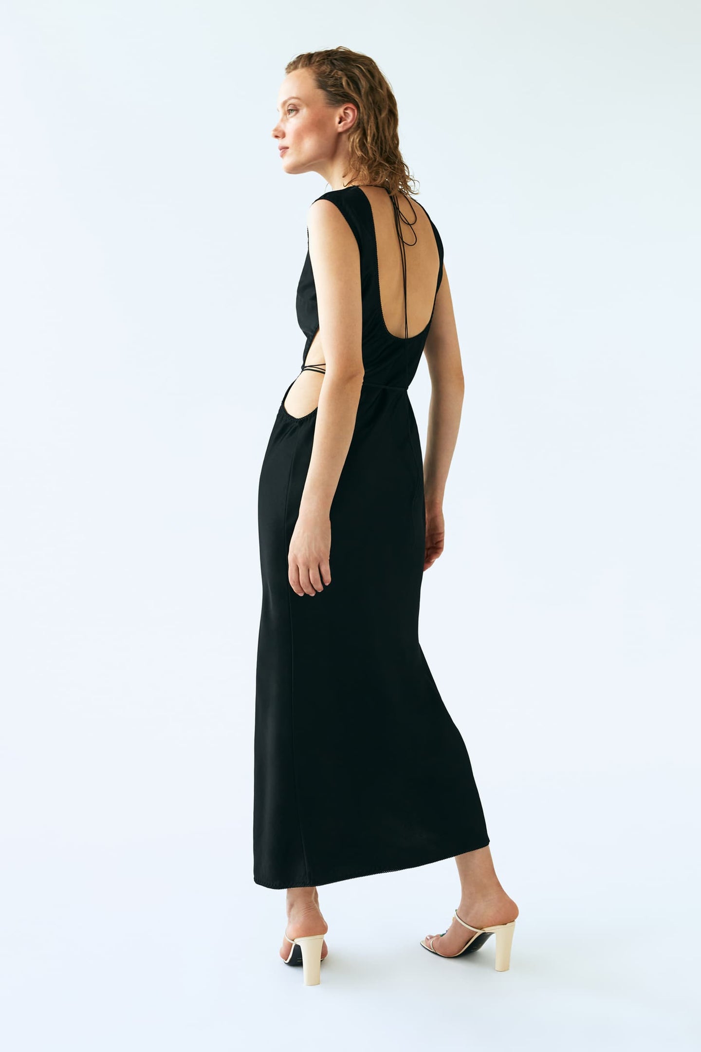 Model in Shu black dress back view