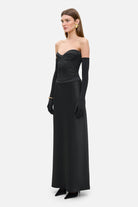 Model in silhouette Delancy maxi dress with a corset bodice side view