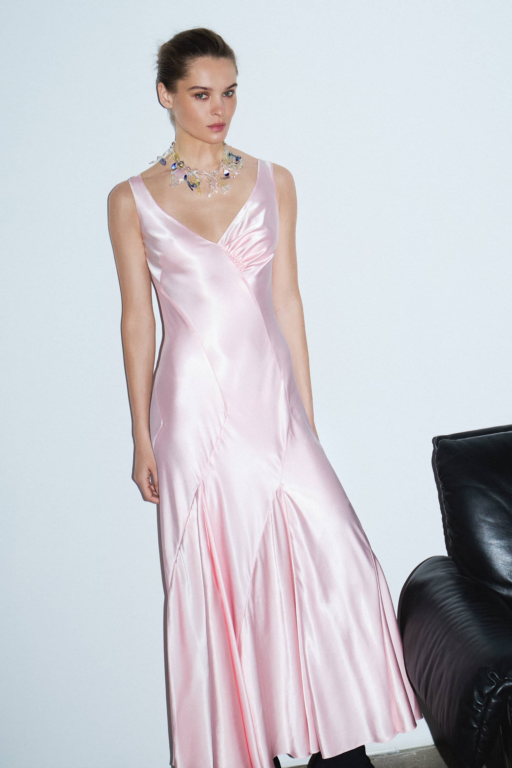 Woman wearing a light pink Liza dress against a white background