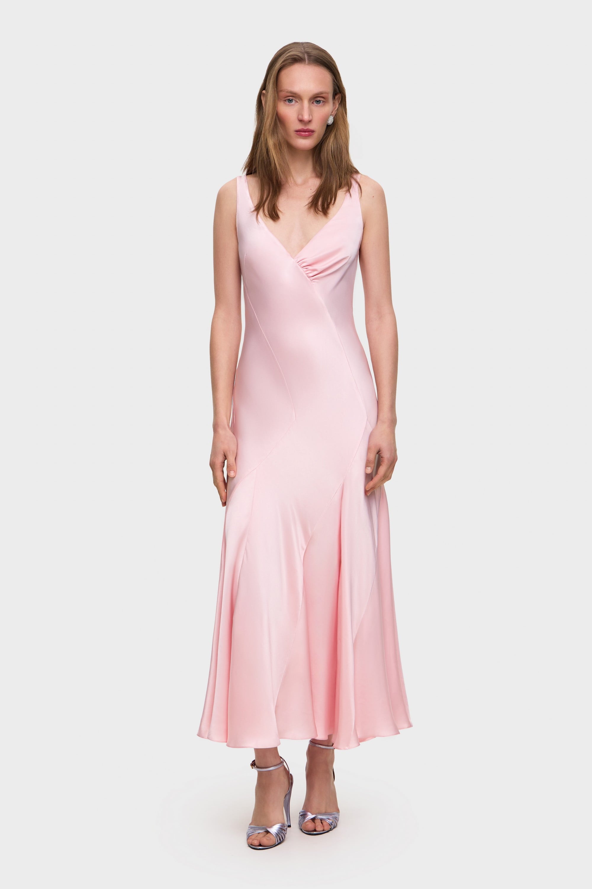 Woman wearing a pink Liza dress on a white background, front view