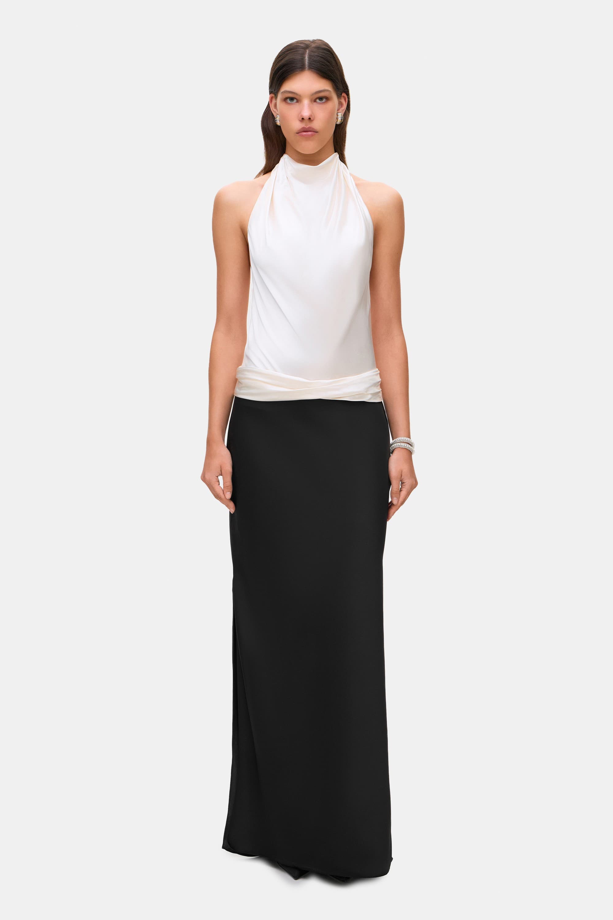 Woman wearing a two-tone Ayla dress with a white top and black skirt on a white background, front view