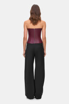 Woman wearing a black wide-leg Katherine pants on a white background, back view