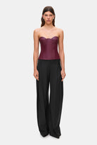 Woman wearing a black wide-leg Katherine pants on a white background, front view