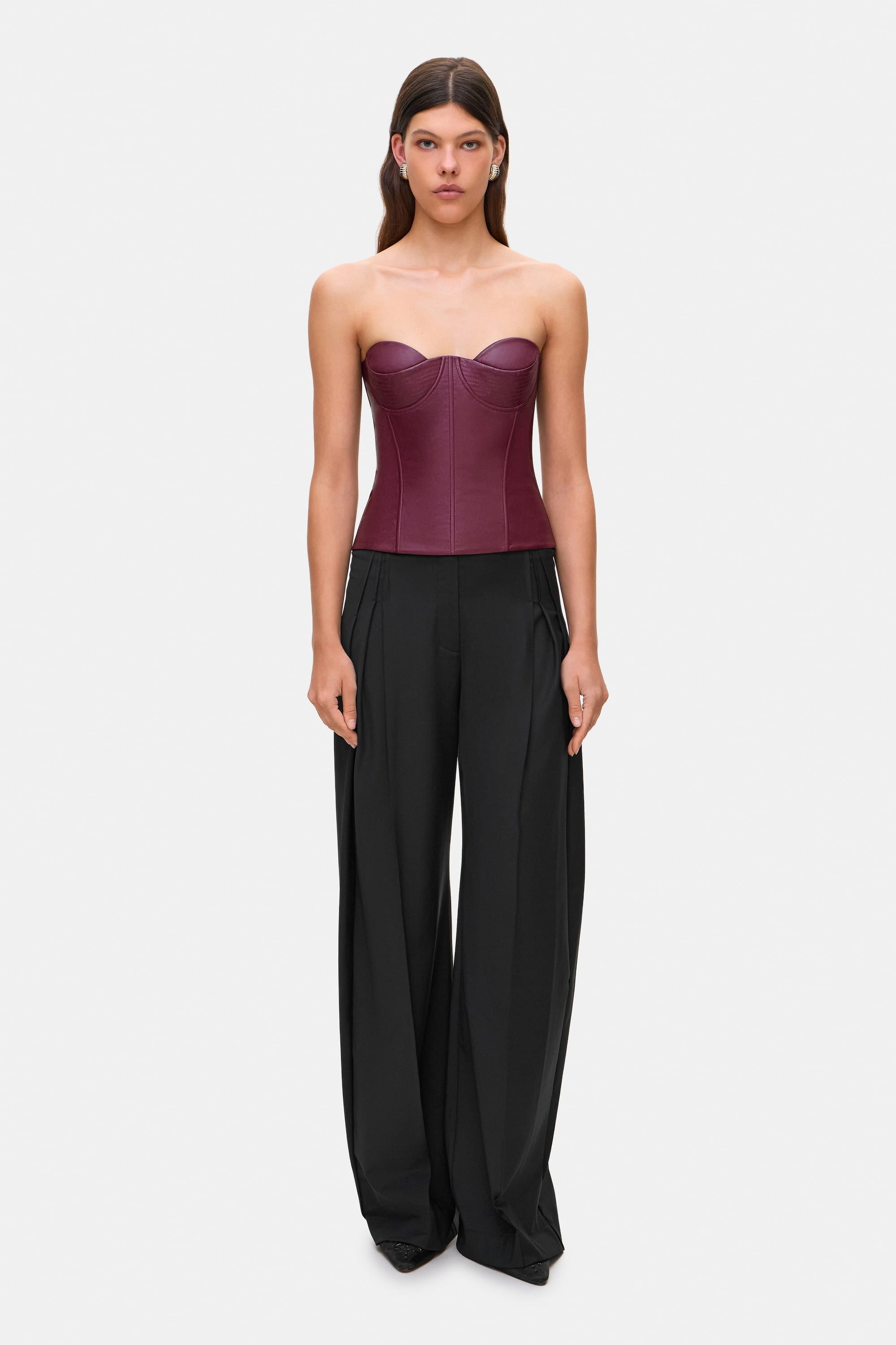 Woman wearing a black wide-leg Katherine pants on a white background, front view
